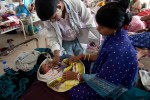Ushara, 22, was given an expected date of arrival by boat clinic staff and decided to make the trip to Dibrugarh, the nearest district hospital, for the birth of her second child. Government incentives pay both the families and ASHAs (Accredited Social Health Activists, government sponsored local health educators and monitors) for each baby born in a hosptial. If the baby is a girl, a savings account is opened with 5000 Rps (approx 110 USD), available to the girl on her 18th birthday, a scheme started to curb female infanticide. 