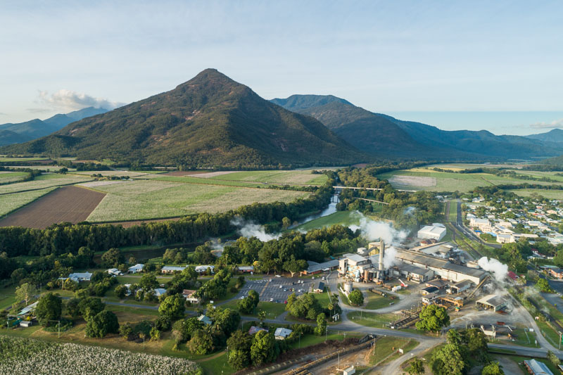 Aerial view of sugar mill with Walsh's Pyramid beyond, Cairns