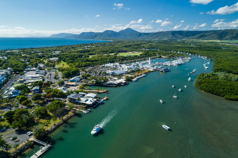Aerial view of boat leaving Port Douglas harbour with Dickson Inlet beyond