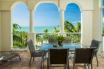 Apartment terrace overlooking tropical beach at Sea Change Beachfront Apartments
