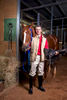 Portrait of jockey standing beside horse in stables