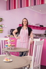 Portrait of female business owner in her cupcake bakery and cafe, Cairns
