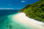 Aerial view of clear waters and white sands of Nudey Beach on Fitzroy Island, Cairns