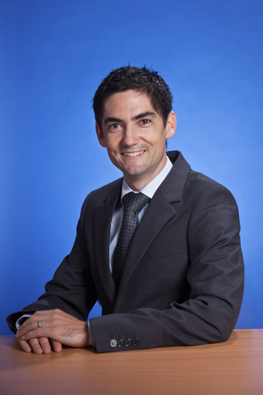 Portrai  of male banking business manager with dark blue background, Cairns