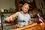 Waitress pouring rum for tasting at Mt Uncle Distillery, Walkamin