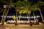 Guests eating outdoors under palm trees at Palm Cove, near Cairns - event photographer Cairns