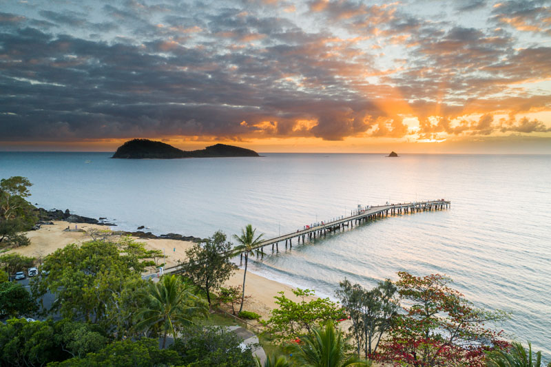 Sunrise aerial view of jetty with island beyond, Palm Cove, Cairns
