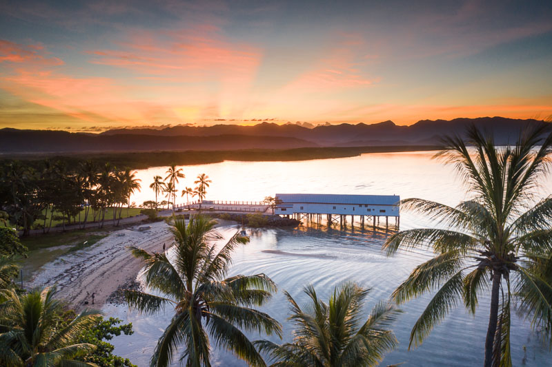 Aerial view of the sun setting behind Sugar Wharf and Dickson Inlet, Port Douglas
