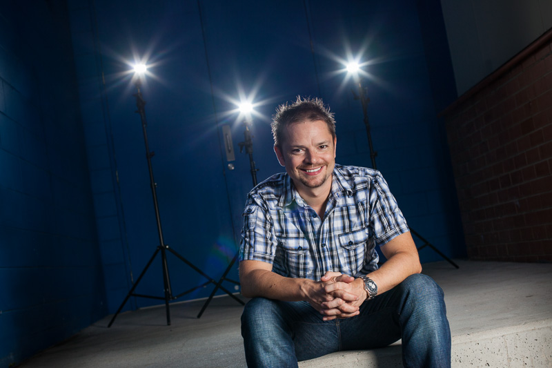 Image of male actor on stage with lighting behind, Cairns