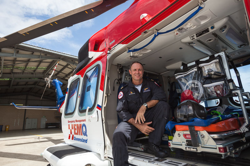 Portrait of male emergency rescue worker sitting in helicopter 