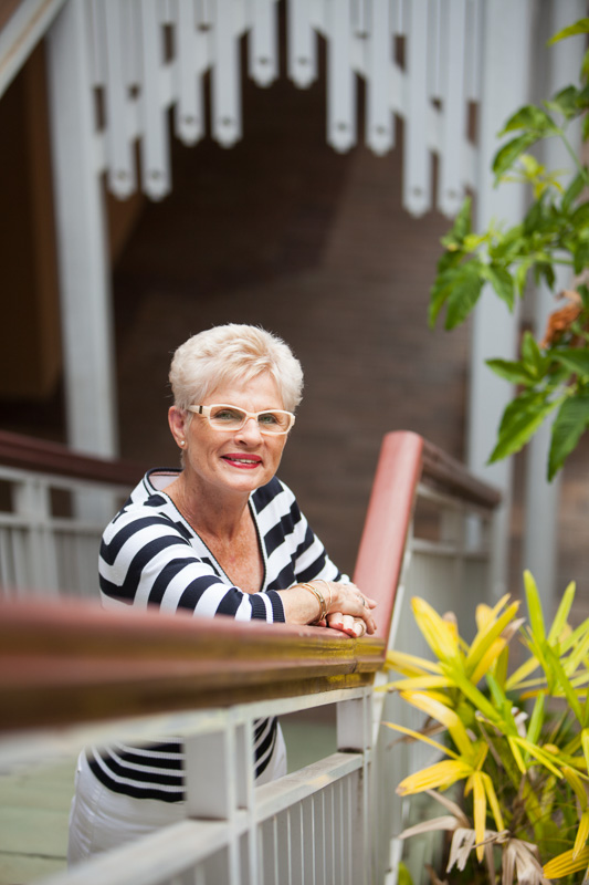 Portrait of female business owner standing on steps of building, Cairns