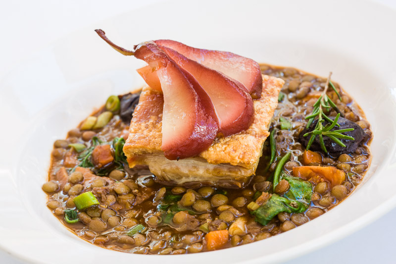 French dish of pork belly with lentils and poached pear at C'est Bon Restaurant by food photographer, Cairns