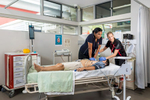 A nursing student practicing CPR with her teacher watching on, Cairns