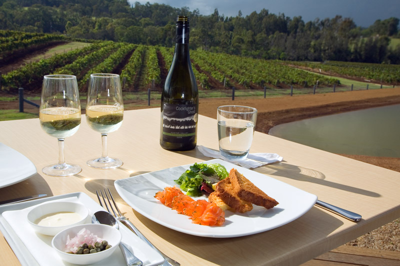 A restaurant dish and wines overlooking vineyards 