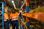 Two workers checking stores shelves at an earthmoving equipment business, Cairns