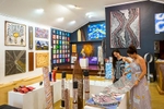 Shop assistant helping a woman shopping in an indigenous art gallery