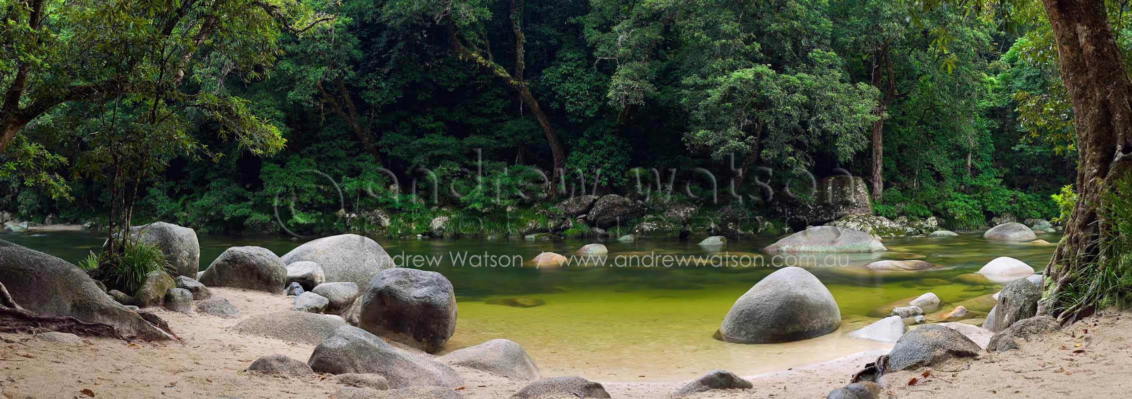 Image of clear waters and boulders at a popular swimming spot in Mossman Gorge