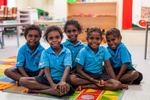 Group of young aboriginal students smiling in the classroom, North Queensland
