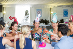 Ladies in racing fashions celebrating at Cairns Amateurs Racing Carnival 

