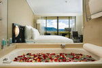 Bathtub with rose petals in hotel room at Hilton Cairns
