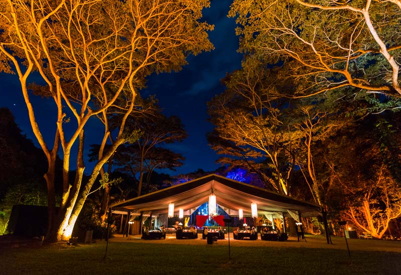 Flames of the Forest dinner venue illuminated at night, Port Douglas
