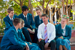 A high school principal talking with group of senior students