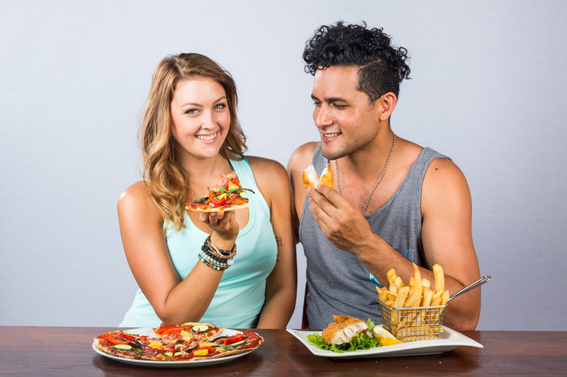 Couple enjoying a pizza and fish and chips at Frydays Fish & Chippery in Cairns