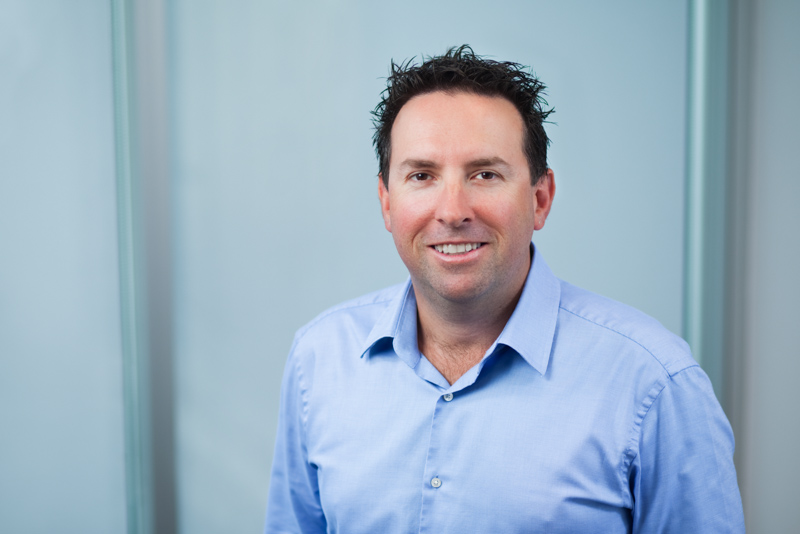 Professional head shot for male accountant with office background, Cairns