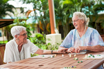 Elderly friends laughing together at New Horizons Villas in Cairns