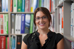 Business headshot of female architect with bookshelves background, Cairns
