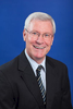 Headshot of male banking business manager with dark blue background, Cairns
