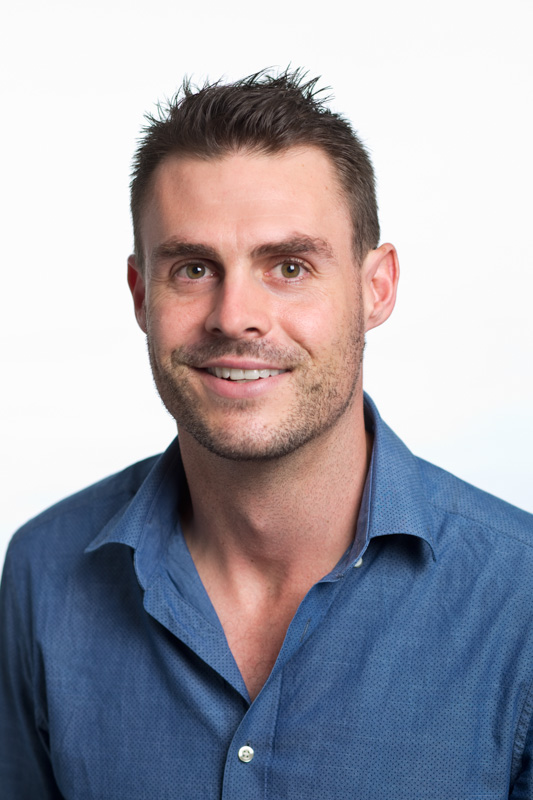 Corporate headshot of male teacher against white background for Cairnseducation firm