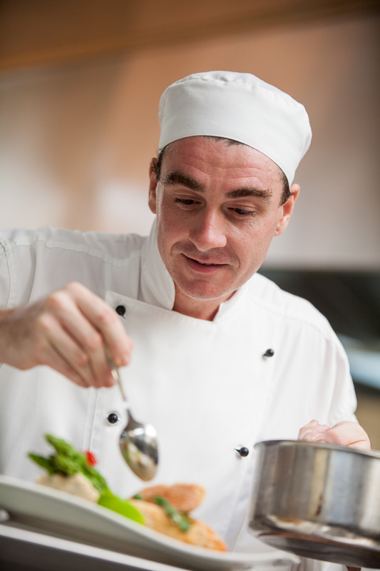Portrait of a chef preparing a dish at Tamarinds Restaurant in Cairns