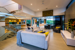 Interior image of living room and outdoor dining area at Marina Quay property, Cairns