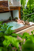 Couple relaxing in outdoor spa at The Reef House, Palm Cove
