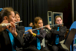 School students playing instruments in school orchestra performance