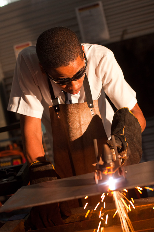 A student wearing protective gear learning oxy acetylene cutting