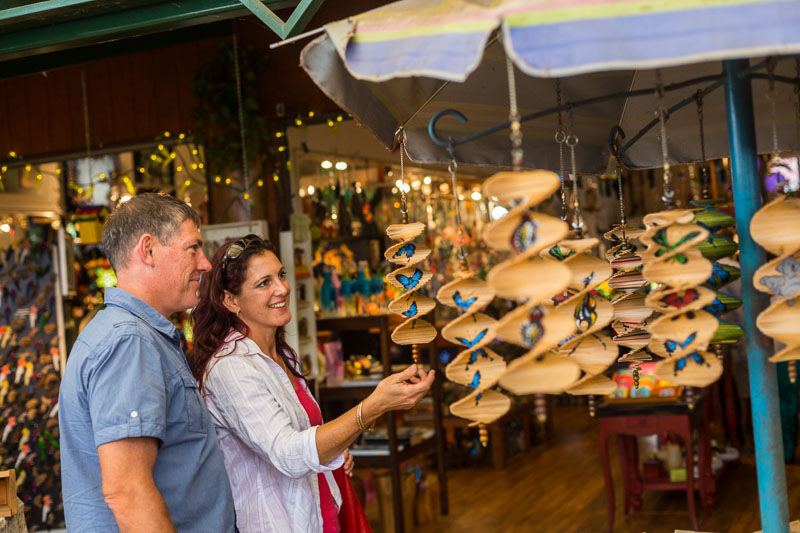 Mature couple looking at tourist handicrafts in a local market