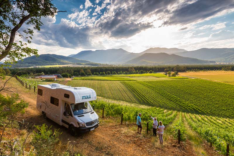 Campervan parking overlooking vineyards with couple getting a personalised tour of winery