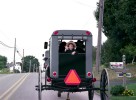 Driving behind a Amish wagon, totally spontaneous, Amish kid waved at me while pointing my camera. 
