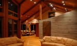 Living room / greatroom showcasing exposed concrete and cherry wood paneling in a custom designed home by Pavelchak Architecture in Valle Crucis, North Carolina, near Boone 