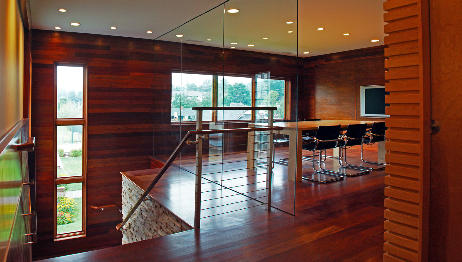 Pavelchak Architecture's conference room showcasing modern, clean design aesthetic with beautiful brazillian cherry and maple hardwoods set against a stunning glass wall.   Located in downtown Banner Elk, North Carolina near Boone. Custom conference table by Miter's Touch.Custom conference table by Miter's Touch.