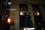 Two Occupy Wall Street protestors kiss atop a telephone booth.  New York Police evicted Occupy Wall Street protestors from Zuccotti Park on November 15, 2011.