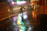 A man dashes across Jamaica Avenue as rains from Hurricane Irene intensified.