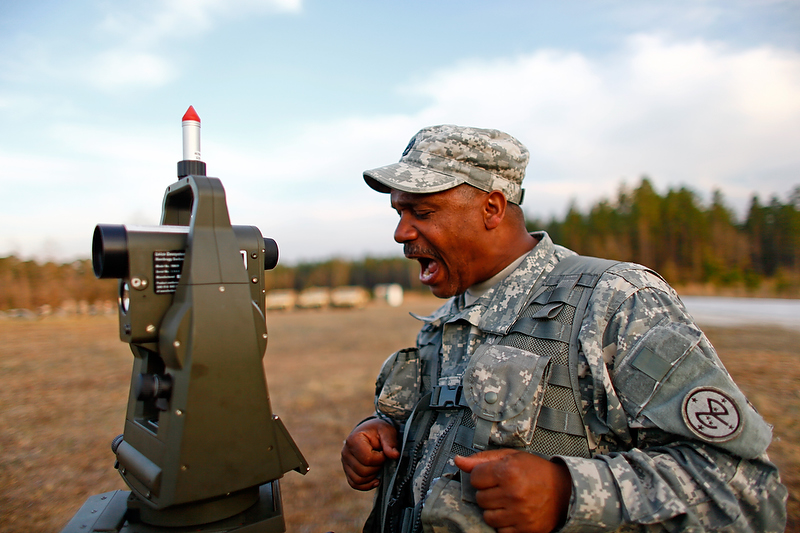 Sgt. 1st Class Suarez screams out data he reads off his gun laying and positioning system.