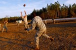 Soldiers organize an ad hoc game of football.