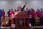 United Church of Jesus Christ Elder Richard McDonald (center) worships with his congregation on Dec. 27, 2009.