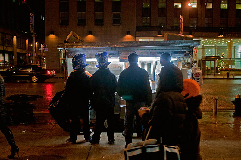 Hungry New Years revellers stop for a snack on 6th Avenue on Jan. 1, 2010.