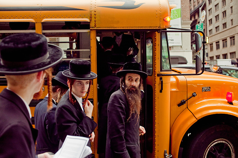 Orthodox Jews board a bus after protesting a hospital's practices on Sept. 16, 2009 in Manhattan.  