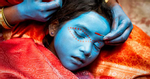Young girl having her face painted in Varinasi, India